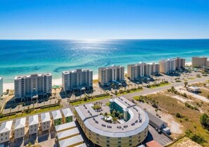A coastal hotel with multiple high-rise buildings, a central circular structure, and a beach view. - Gulf Shores - Sea Breeze 216 2/2 *Beach Access* (Gulf Shores)