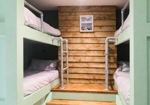 A bunk bed room with wooden walls and a framed picture. - Pitchside Place sleeps 19 (Liverpool)