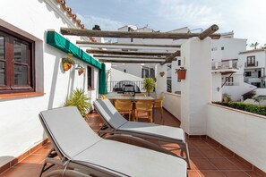 A rooftop terrace with lounge chairs, a table, and a grill. - Casa Bengeo - Two Bedroom Apartment, Sleeps 4 (Nerja)