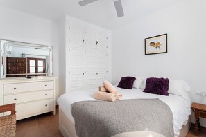 A bedroom with a bed, a dresser, a mirror, a wardrobe, and a framed picture on the wall. - Casa Bengeo - Two Bedroom Apartment, Sleeps 4 (Nerja)