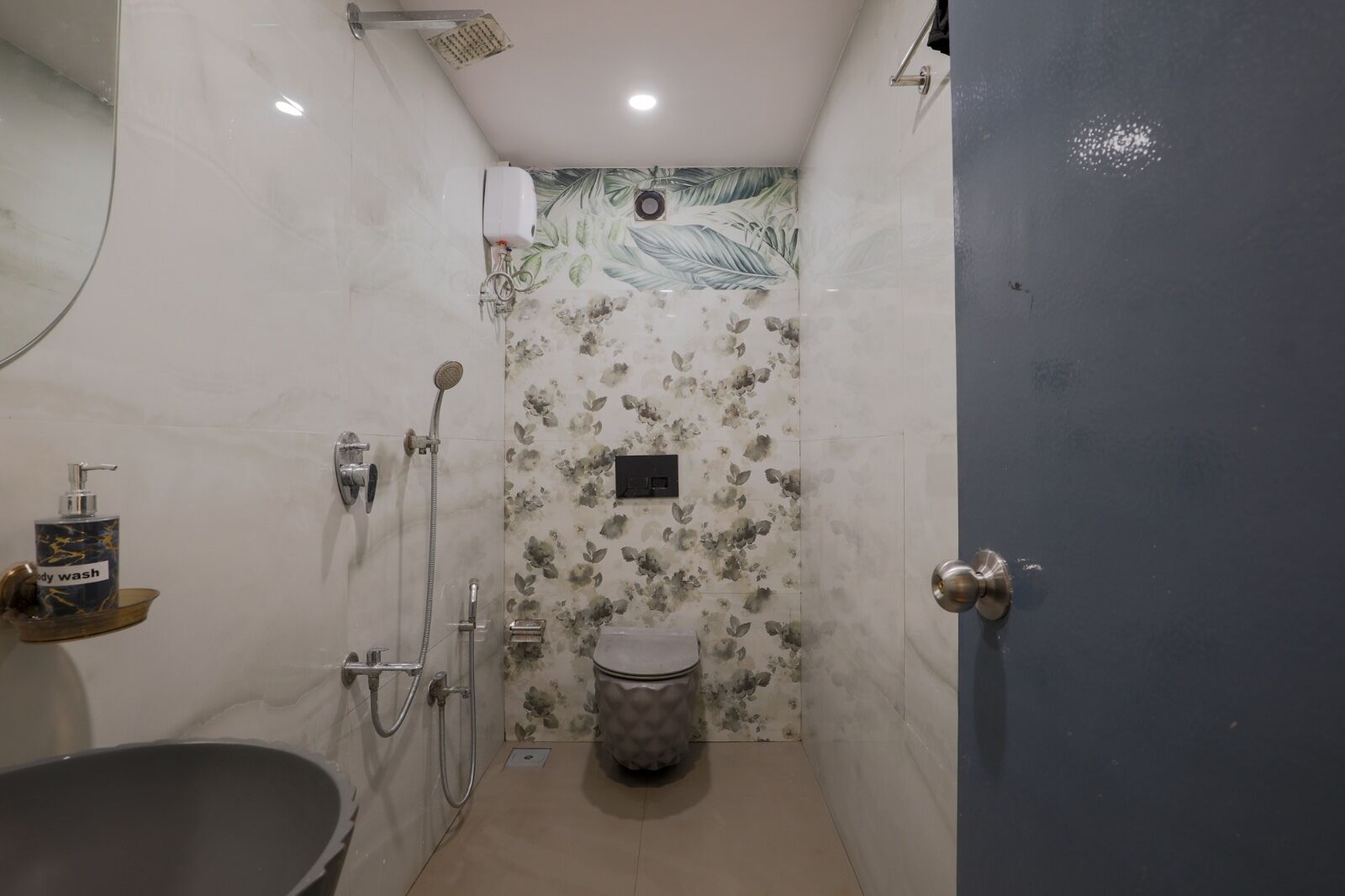 A small bathroom with a shower, toilet, and sink.
