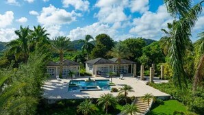 A luxurious resort with multiple villas, a central pool, and lush tropical surroundings. - Villa Zaphira (Puerto Plata)