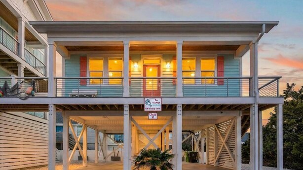 A two-story building with a balcony, a sign indicating 'The COD Stage' and 'Unit 2'. - The CODtage is amazing! 60 steps from beach, 2.5 blks to boardwalk! (Carolina Beach)