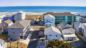 A coastal residential area with beachfront properties, including multi-story buildings with balconies and a mix of architectural styles. - The CODtage is amazing! 60 steps from beach, 2.5 blks to boardwalk! (Carolina Beach)