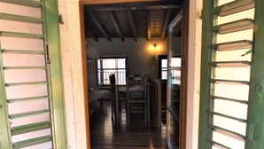 A wooden staircase leading to a room with a bed and a window. - Catullo House in Garda (Garda)