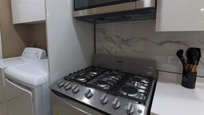 A kitchen with a stainless steel stove, a microwave, and a built-in oven.