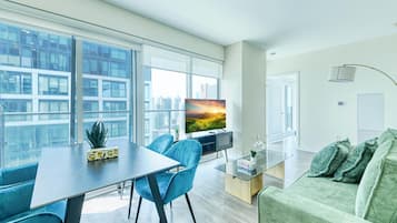 Panoramic Suite, 2 Bedrooms | Living area | 65-inch TV with digital channels