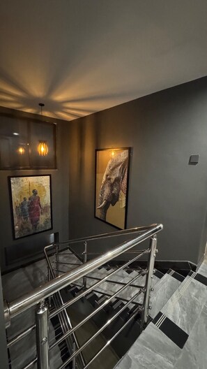 A staircase with metal railings and marble steps. - 3 BR Panoramic Penthouse Duplex (Nairobi)