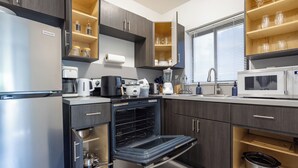 A modern kitchen with a built-in oven, a microwave, and a coffee maker. - Unit 4 - Beautiful 1BR Apt w/Parking Near Biscayne Boulevard (Miami)