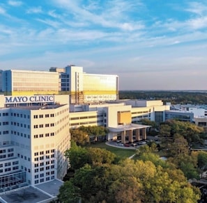 Un edificio de varios pisos con un letrero que dice 'MAYO CLINIC' en el último nivel.