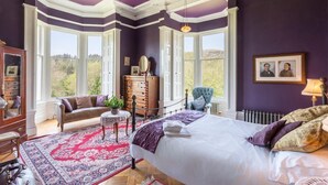 A bedroom with a large bed, a dresser, a chair, and a window. - Argyll Country House (Clachan)