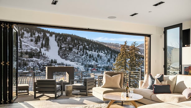A modern living room with a large window overlooking a snowy mountain landscape. - Hot Tub with Slope Views | Walk to Lift (Park City)