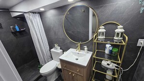 Un bagno moderno con toilette, lavabo e zona doccia.