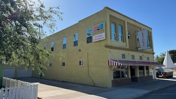 A two-story building with a sign for Upton's Apartments and a Pepsi logo.