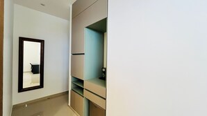 A room with a mirror, a desk, and a shelving unit. - Hotel Murahno (San Jose de Cucuta)