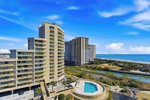 A high-rise hotel with multiple balconies, a swimming pool, and a view of the beach and ocean. - 🌊Stunning Oceanfront | Pool | Ocean Creek South CC-8🌊 (Myrtle Beach)
