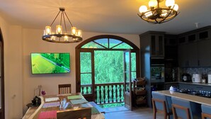 A spacious kitchen with modern appliances, a dining area with a large window, and a cozy seating area. - Casa Colonial Maria Elena (Pereira)