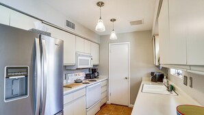 A compact kitchen with a stainless steel refrigerator, a microwave, a stove, and a sink. - Desert Oasis w/ Hot Tub! 6 Mi to Lake Havasu (Lake Havasu City)