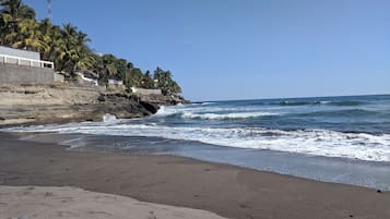 Private beach nearby, black sand