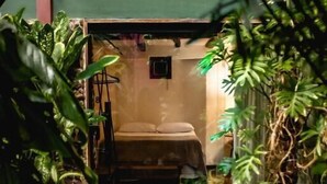 A wooden pathway leading to a room with a bed and a small window. - Cas'Amazonia Brasil (Belém)