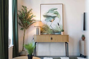 Unwind in a stylish lounge complete with comfortable seating, a Smart TV, and modern décor, creating a welcoming space to relax at any time of day. - Norton 2BR Apartment | Sleeps 4 by Stay With Us (Norton)