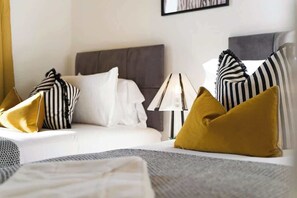 Enjoy a comfortable night's sleep in the second bedroom, complete with two single beds and fresh, soft linen. The window allows plenty of daylight to brighten the room throughout the day. - Norton 2BR Apartment | Sleeps 4 by Stay With Us (Norton)