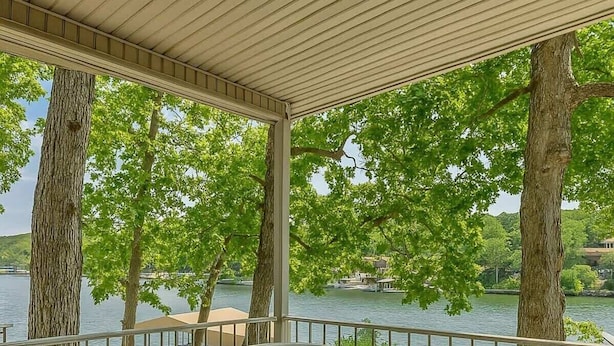 A hot tub on a wooden deck with a view of a lake and trees. - Eagle Ridge Retreat - Dock, Hot Tub & Game Room (Gravois Mills)