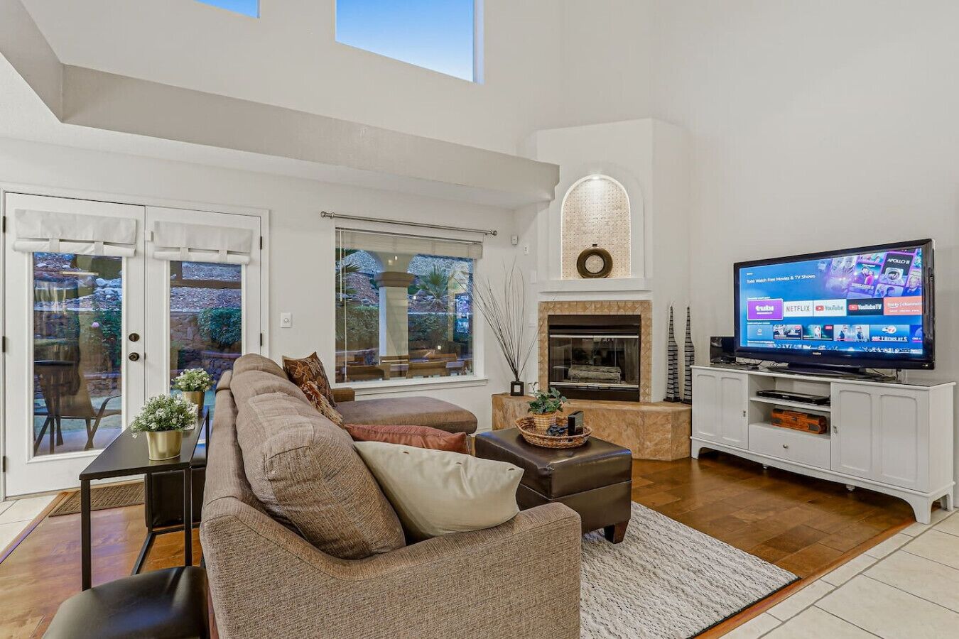A modern living room with a fireplace, a television, and a comfortable seating area.