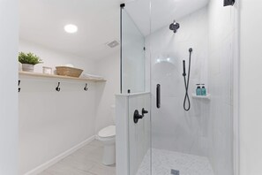 Shower, hair dryer, towels, shampoo