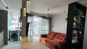 Een moderne woonkamer met een bank, een bijzettafeltje en een boekenkast.