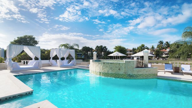 A clear blue pool with white canopies and lounge chairs. - Escape to Paradise 5-star VIP Resort, Private Beaches, Pools & Unlimited Dining (Puerto Plata)