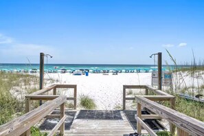 A wooden boardwalk leading to a beach with umbrellas and beach chairs. - Luxury 2-Story Penthouse - Nursery + Private Beach + Gulf Views - Silver Dunes (Destin)