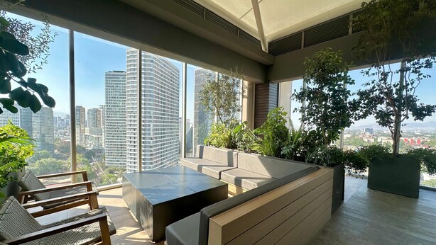 A modern indoor space with a seating area, large windows, and indoor plants. - Studio/Loft Apartment in Vitant by BeGrand Anahuac, close to Polanco. (Ciudad de México)