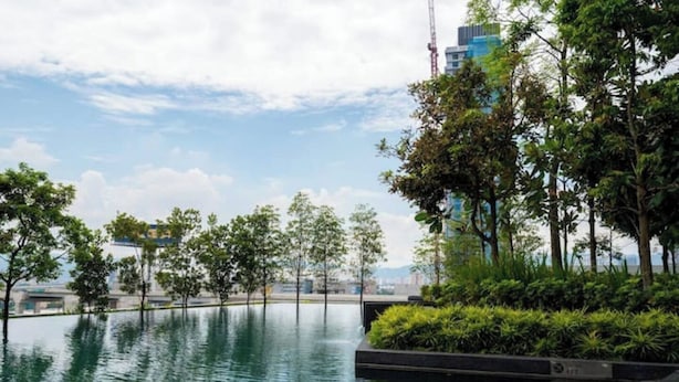A serene outdoor pool area with a clear view of the city skyline in the background. - Narrow Nest 2BR Continew Residence Wi-Fi + Netflix (Kuala Lumpur)