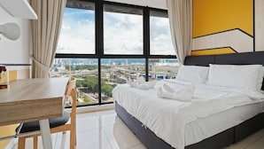 A hotel room with a large window, a bed, a desk, and a chair. - Narrow Nest 2BR Continew Residence Wi-Fi + Netflix (Kuala Lumpur)