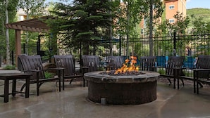 A fire pit surrounded by chairs and tables in an outdoor setting. - Spacious 3 bedroom in Magical Park city Utah (Park City)