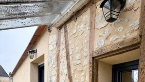 A stone building with a window and a table outside. - Gîtes de France® - Héloïse's gîte (BETAILLE)