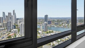 A high-rise building with a view of a cityscape and a river. - Ruby 30F Sunset Penthouse | Ocean & City Views (Surfers Paradise)