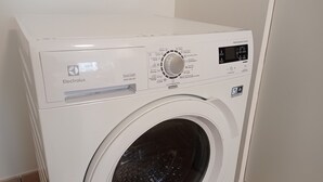 A front view of a white washing machine with a control panel, brand name Electrolux, and various washing cycle options. - Two bedrooms apartment with free underground parking place (Etterbeek)