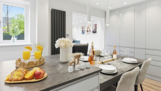 A modern kitchen with a breakfast setup, including a fruit plate, drinks, and a vase of flowers.