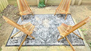 Four wooden chairs arranged around a patterned rug in an outdoor setting. - Central MSU Explorer`s Nest 2BR (Starkville)