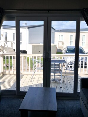 A room with a sliding glass door leading to an outdoor deck.