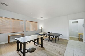 A room with three tables, a bench, and a door. - 4 bedroom 2 bath home with pool, wi-fi, laundry (Mesa)