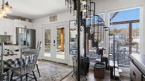 A modern kitchen with a dining area, large windows, and a view of the outdoors. - Lakefront w/ Private Dock, 2 Slips, Swim Mat, Firepit, & Covered Patio 44mm (Roach)