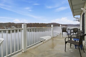 A balcony with a view of a lake and distant trees. - Lake Views & Loft Retreat for Kids w/ 12x30 Slip at Mm11 (Sunrise Beach)