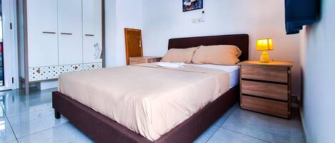 Tabla de planchar con plancha, internet y ropa de cama