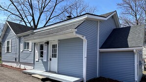 A single-story house with a front porch, a garage, and a small attached shed. - Farmhouse in the Heart of DowntownAuburn Hills (Auburn Hills)