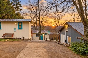 A rustic cabin with a bench, a small shed, and a sign indicating reserved parking. - Immerse in Julian Cozy Cabin w Fireplace & Deck (Julian)