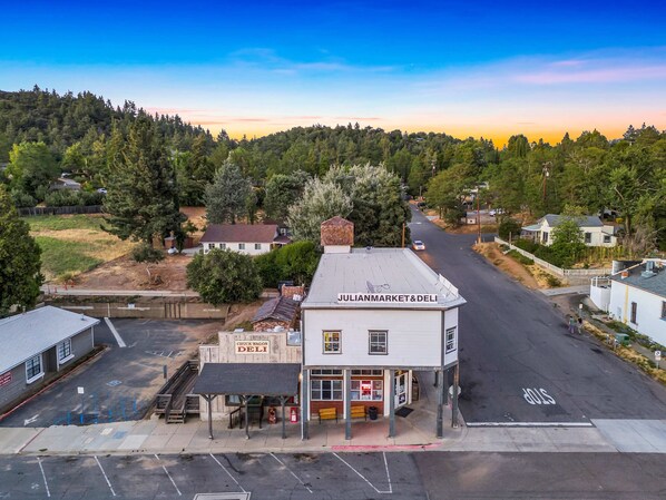 A Julian Market & Deli with a small parking lot and a stop sign at the intersection.