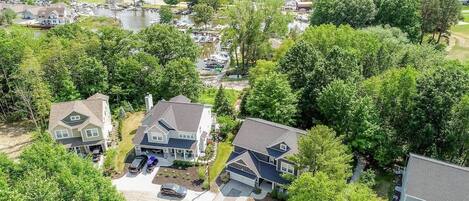 An aerial view of a residential area with houses, a lake, and a marina.